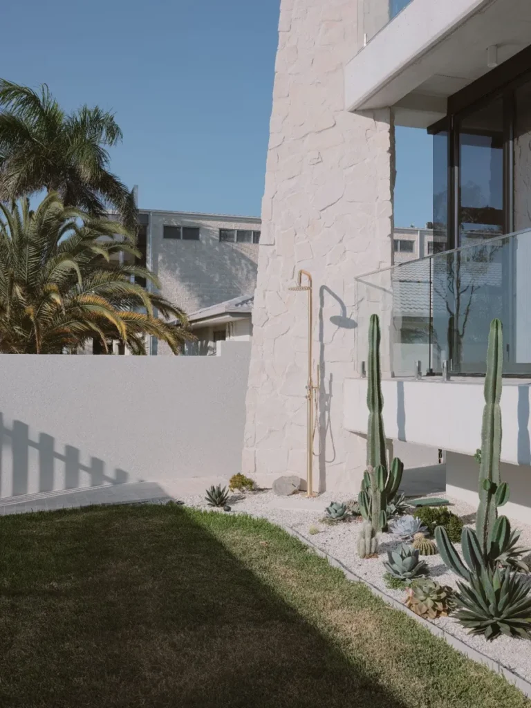 Your Guide to Cement Render: Everything You Need to Know modern outdoor shower with plants in front of a stone wall