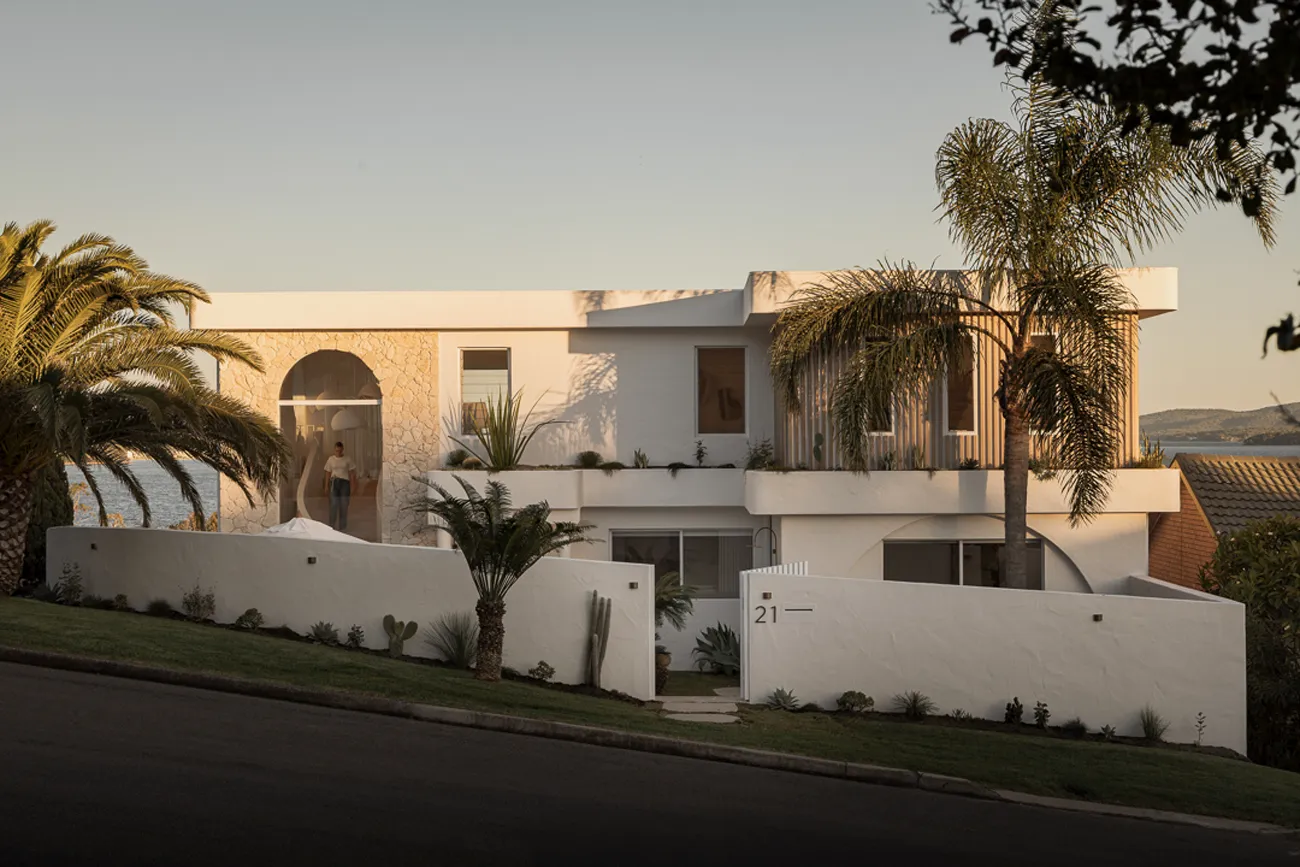 What Are the Best Brands for Textured Wall Paint in Australia? landscape image of a two storey coastal house with palm trees